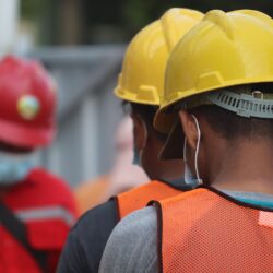 Construction workers wearing yellow safety hats